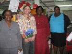 Ms. Dorothea Nelson, Chief Librarian, Antigua Public Library, with author Mario Picayo and library staff members