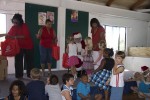 Everybody's favorite moment. Santa hands the children their gift- the beautiful and practical bag, and inside?" Efa and the Mosquito".