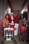 More smiles as Santa and First Lady Cecile de Jongh pose with students and teachers. Juanita Gardine Elementary School, St. Croix